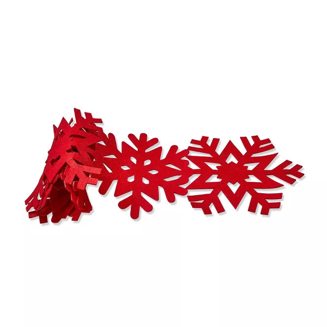 Red felt snowflake runner partially rolled up.