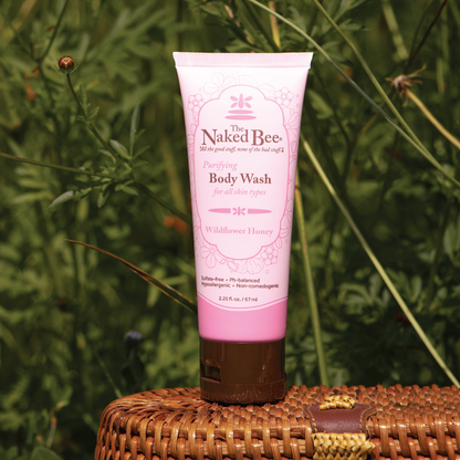 tube of wildflower body wash set on a basket in a meadow