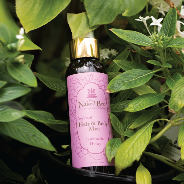 bottle of Jasmine & Honey hair and body mist set with a jasmine plant