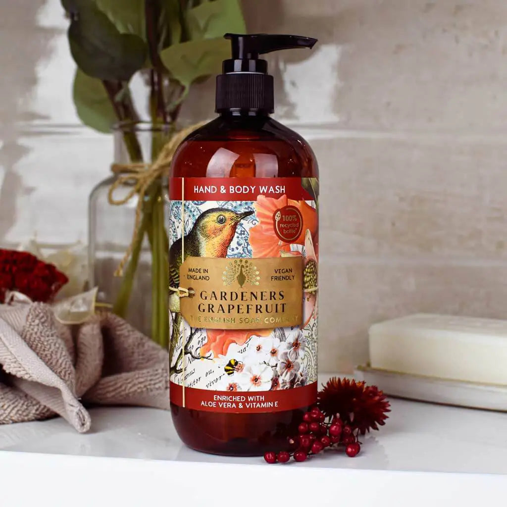 Hand and body wash bottle with decorative label of floral and bird on a bathroom counter