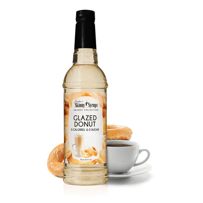 syrup bottle in front of 2 glazed donuts and a cup of coffee