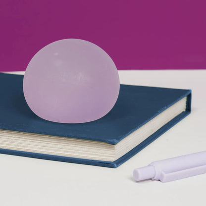 Purple sphere on a blue book with a purple background