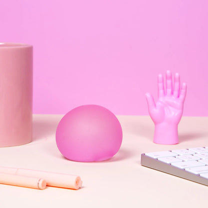 Pink spec memory gel stress ball on pink color themed desk
