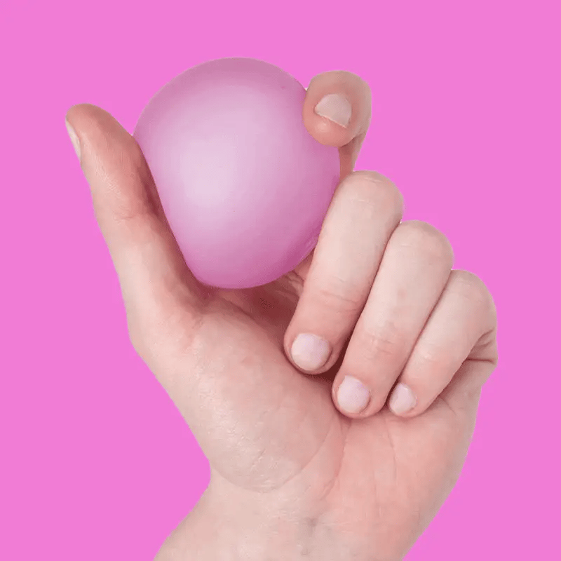 video of a hand squeezing Pink spec memory gel stress ball