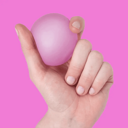 video of a hand squeezing Pink spec memory gel stress ball