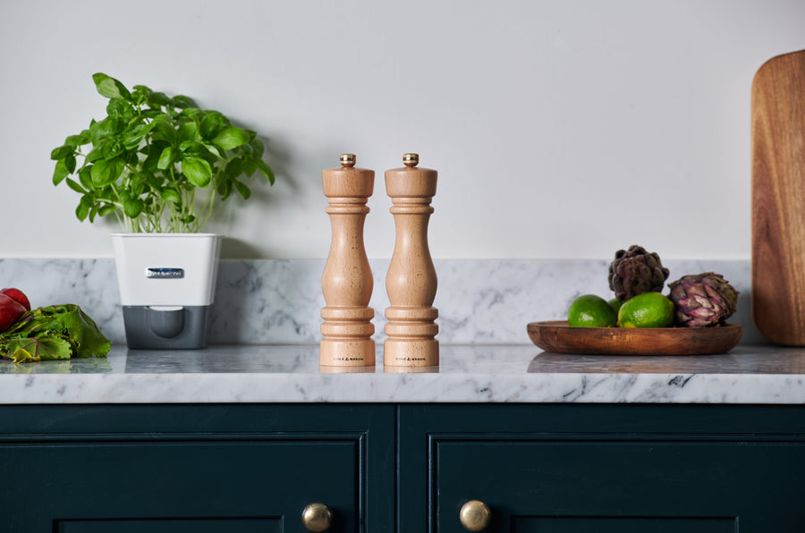 london natural mills set on a marble countertop with produce and herbs.
