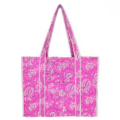 Pink tote bag with white floral pattern on a white background