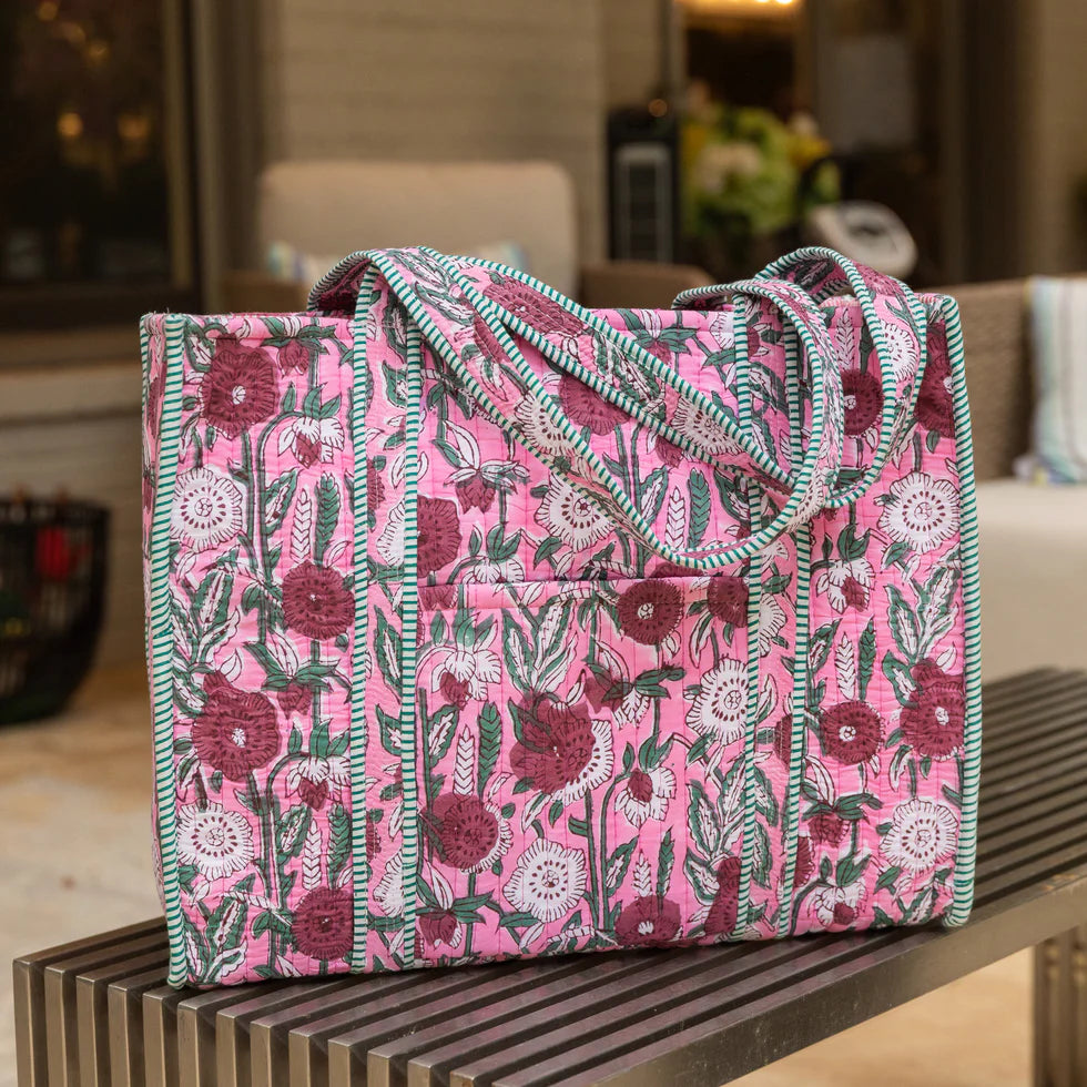 Floral patterned bag on a wooden surface with a blurred indoor background