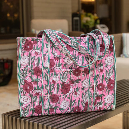Floral patterned bag on a wooden surface with a blurred indoor background