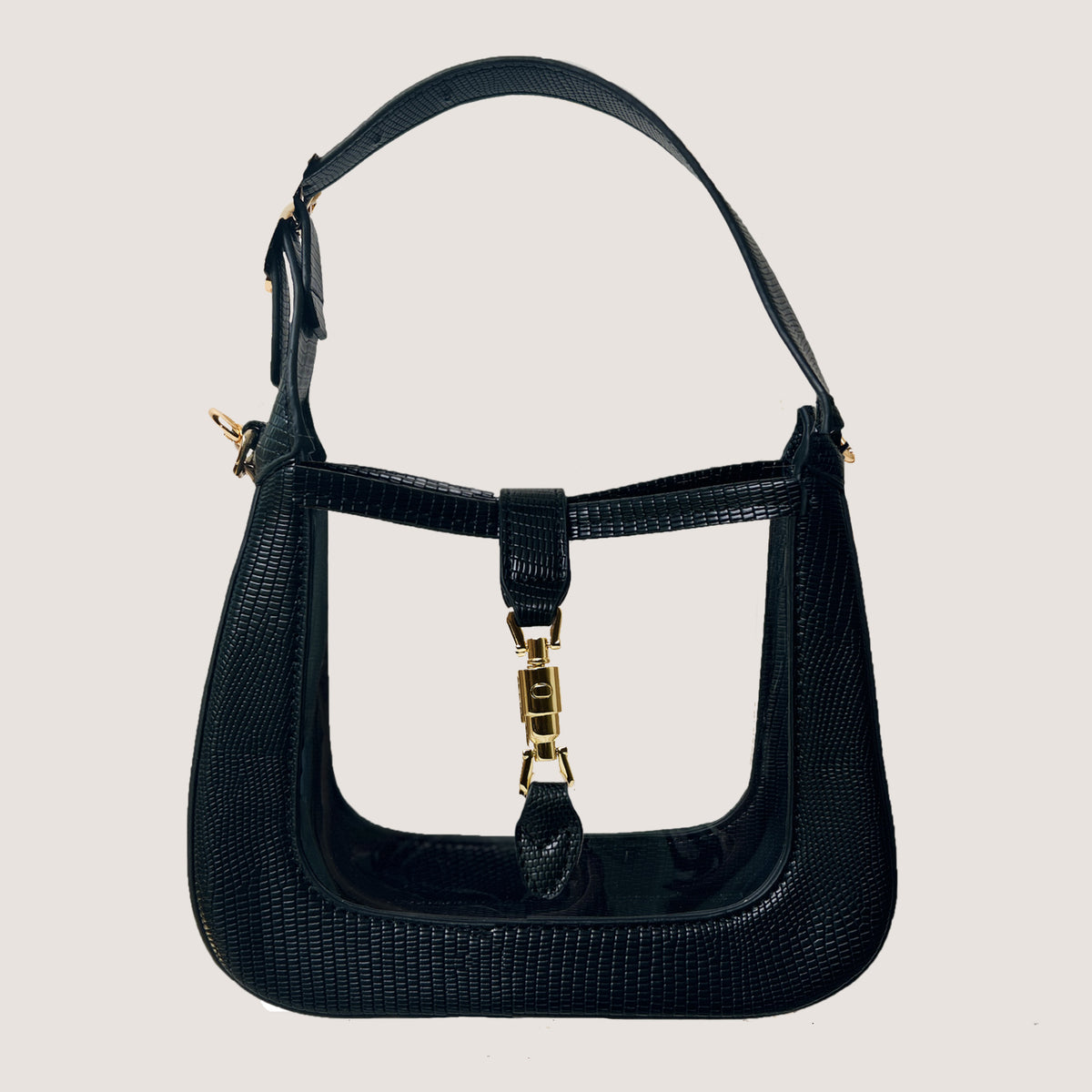 The Paige Clear Stadium Bag in Black on a taupe background
