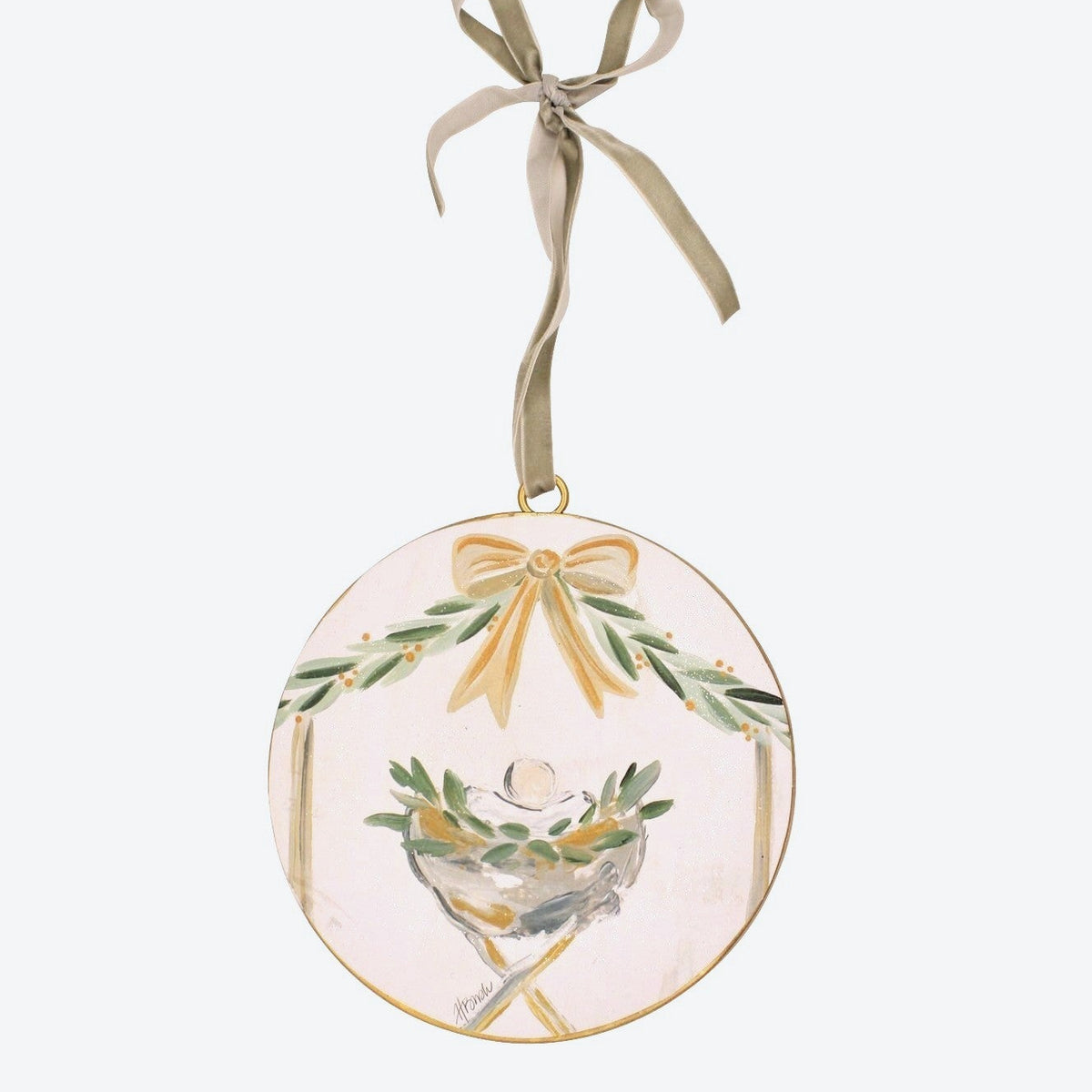 watercolor-look manger ornament with taupe ribbon hanger on a white background