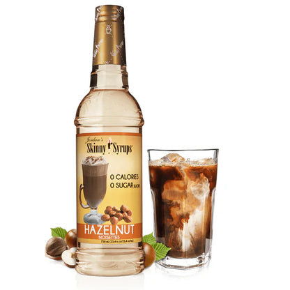 bottle of hazelnut skinny syrup set next to an iced coffee beverage