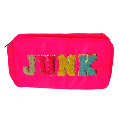 hot pink zipper bag with "junk" stitched on it in chenille letter patches.