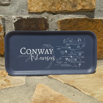 Navy blue tray with 'Conway Arkansas' text and map design on a stone surface