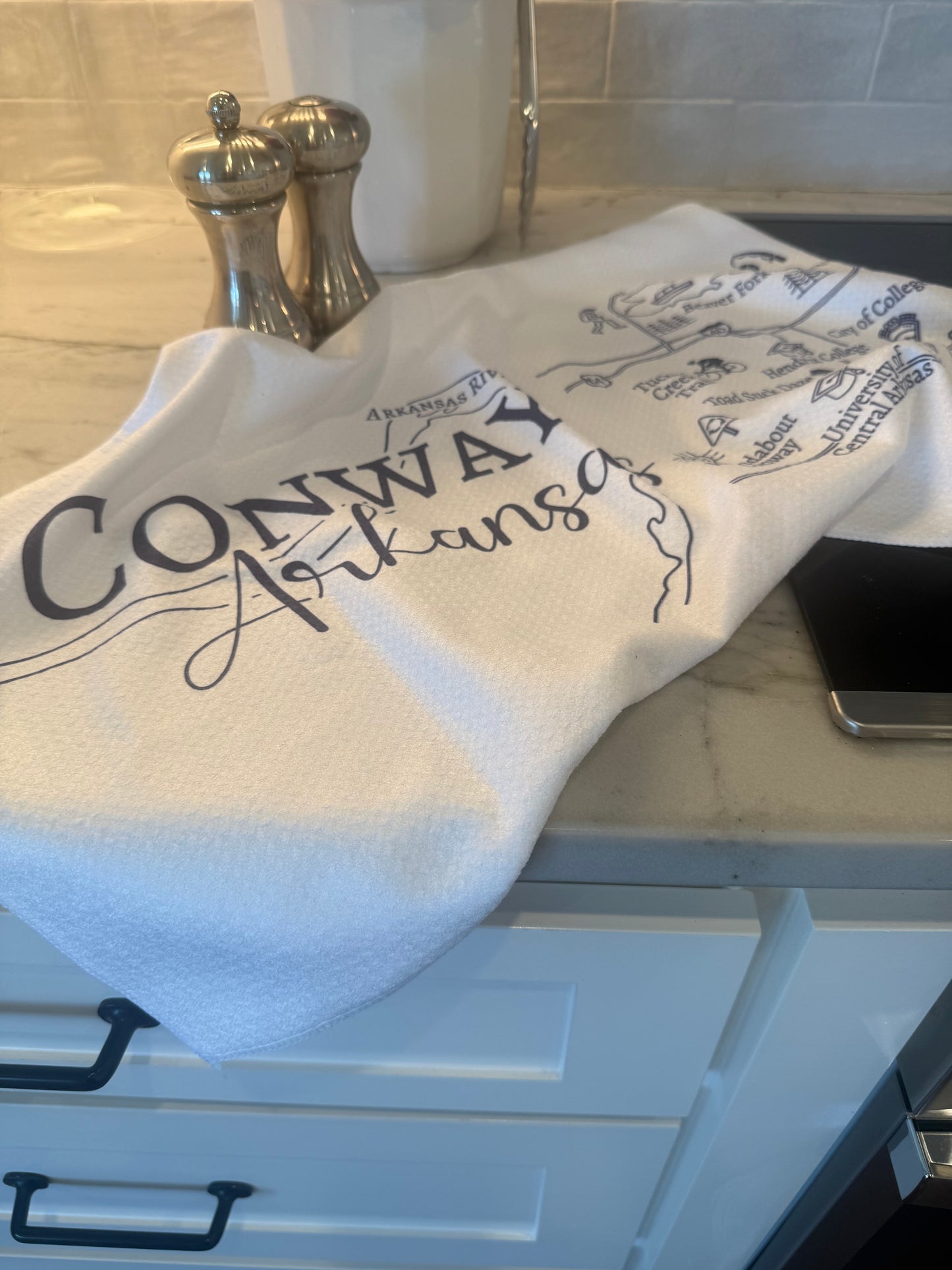 towel printed with Map of Conway, Arkansas draped on a countertop