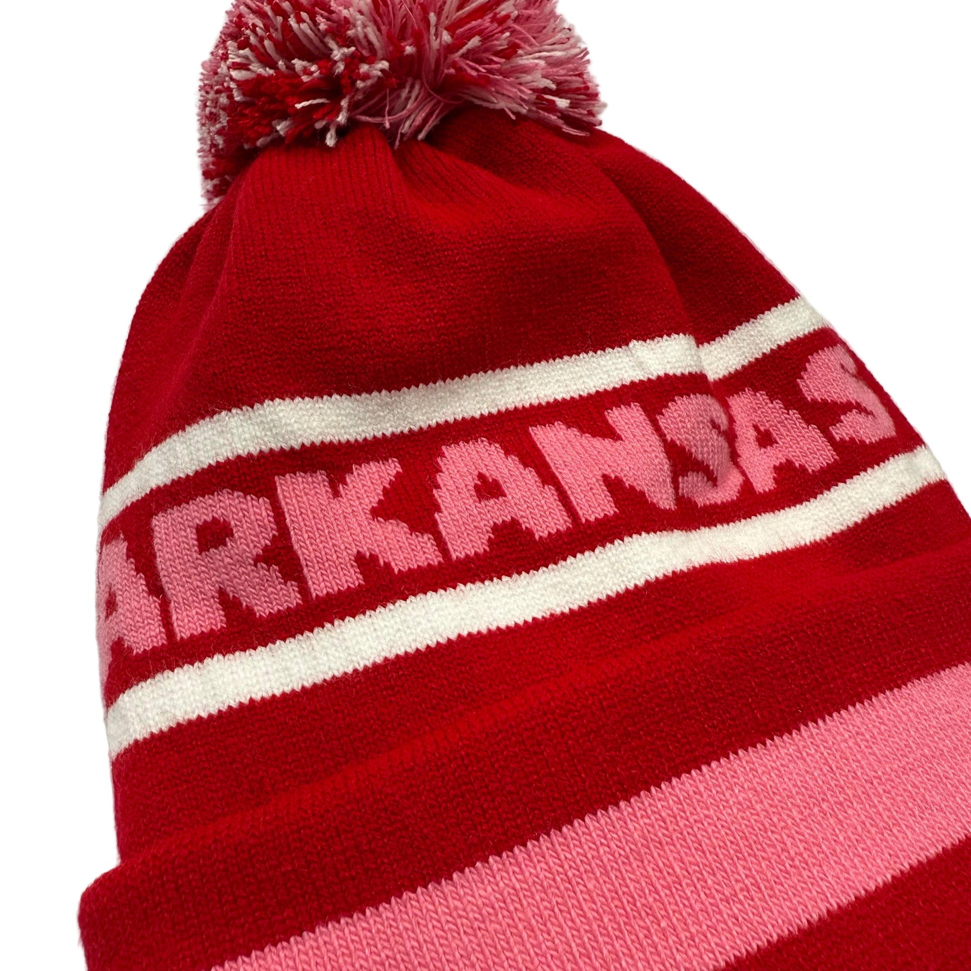 close-up of Red  beanie with pink and white stripes and 'ARKANSAS' text in pink on a white background