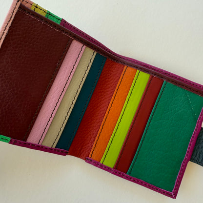 interior view of Colorful striped leather wallet on a light background