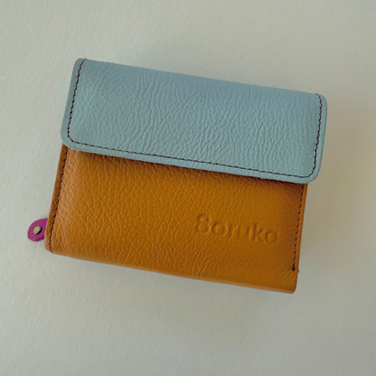 Two-tone wallet with light blue top section and brown bottom section on a white background