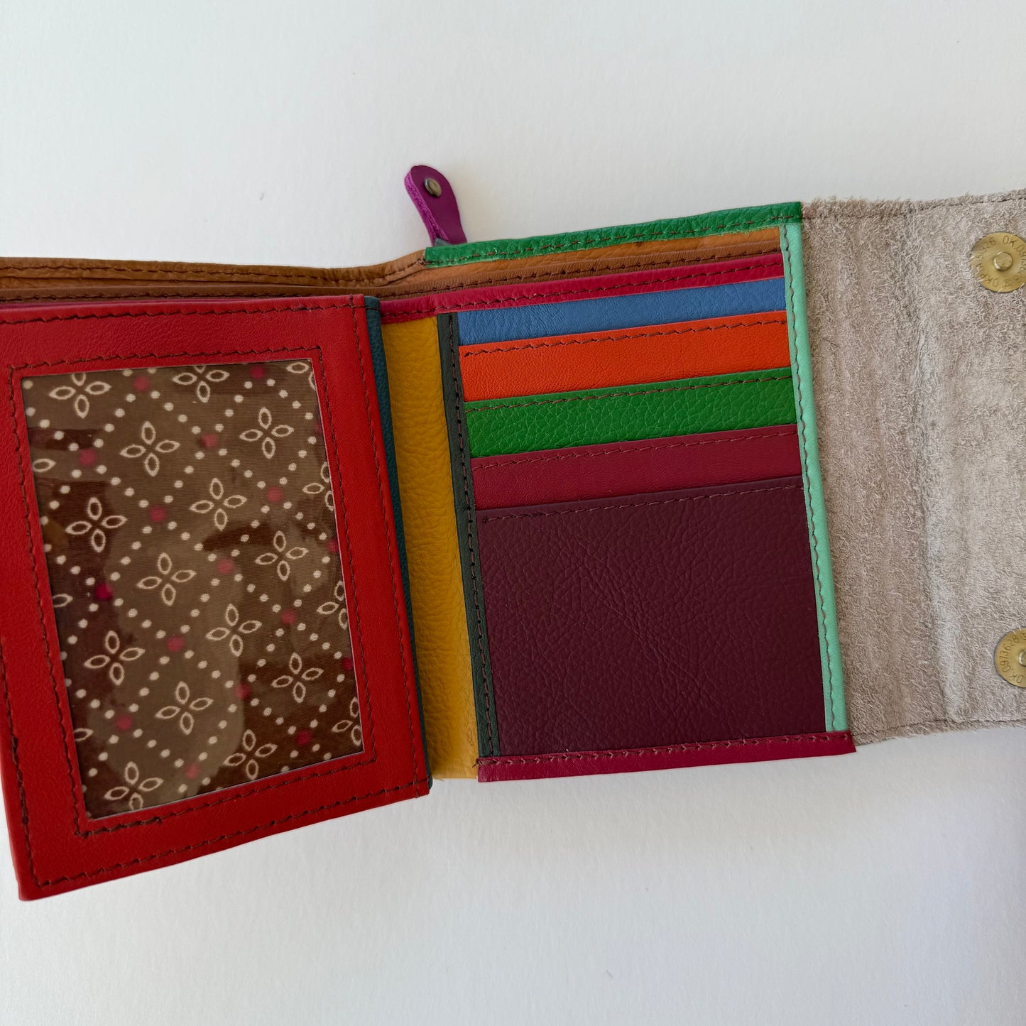 open view of Multicolored fabric wallet with corlorful card slots on a white background