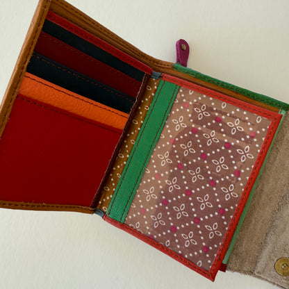 Open wallet with colorful card slots and clear ID pocket on a white background