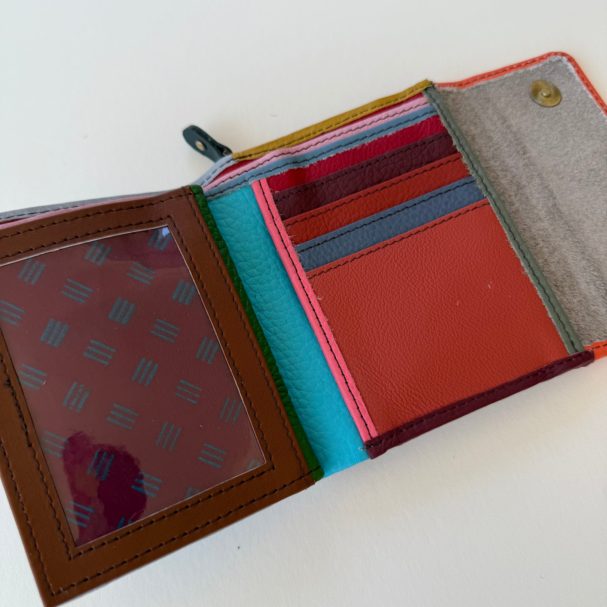 Open multicolored wallet with card slots on a white background