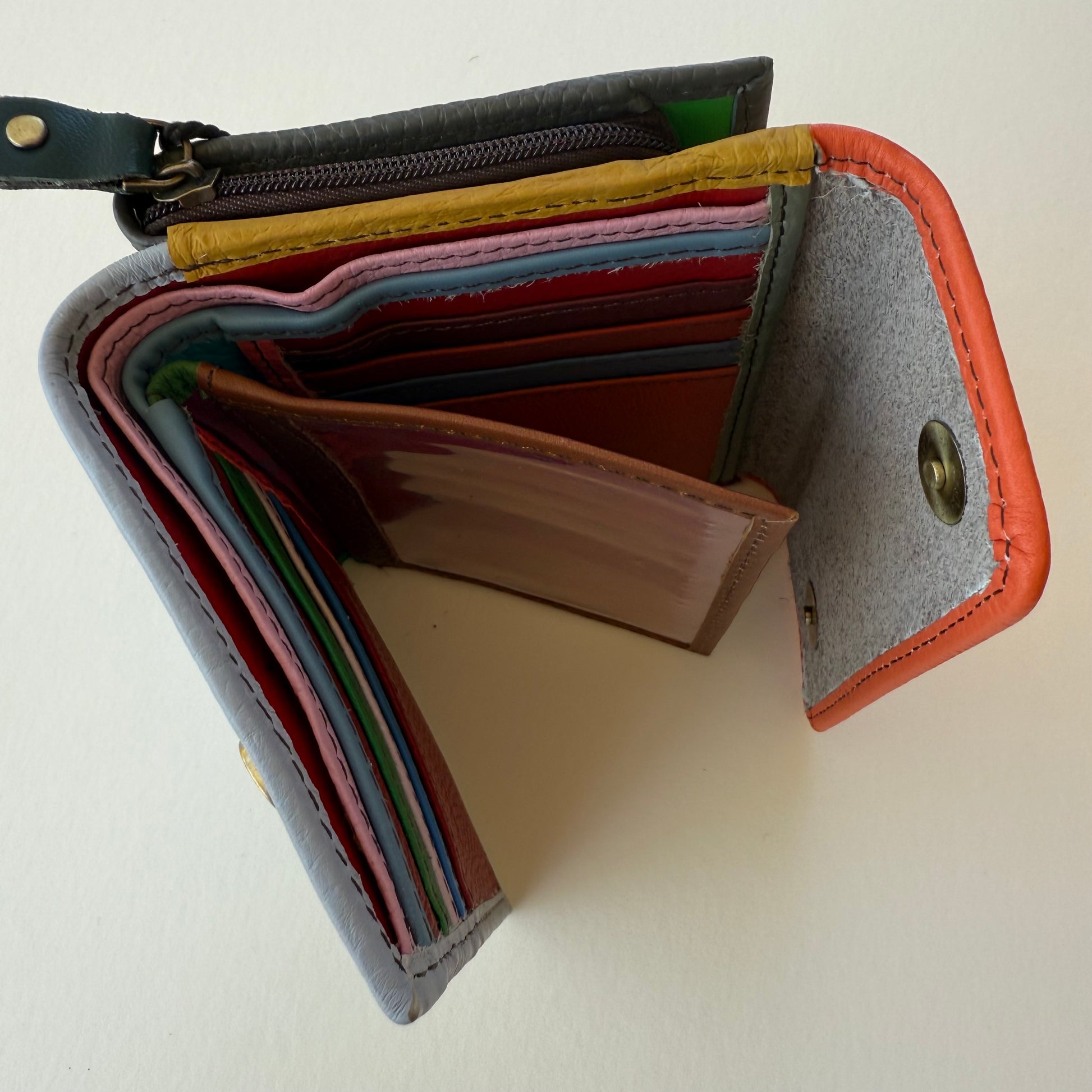 top view of Multicolored wallet with multiple card slots on a light background