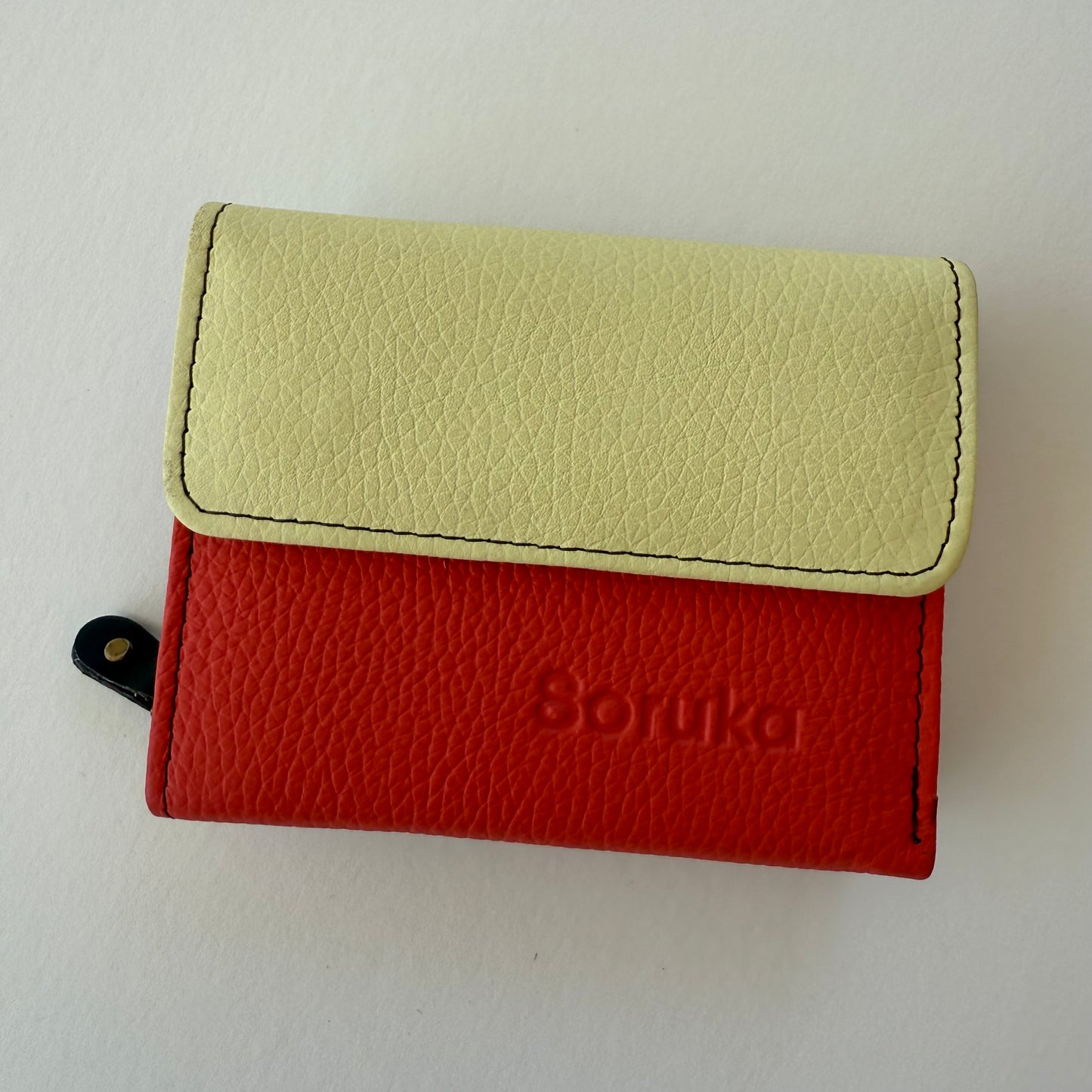Two-tone red and yellow wallet with on a white background