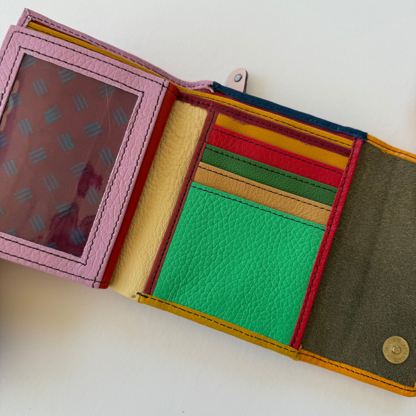 interior view of Multicolored leather wallet with various card slots on a white background