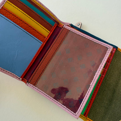 Multicolored leather wallet open showing corlorful card slots and clear ID pocket