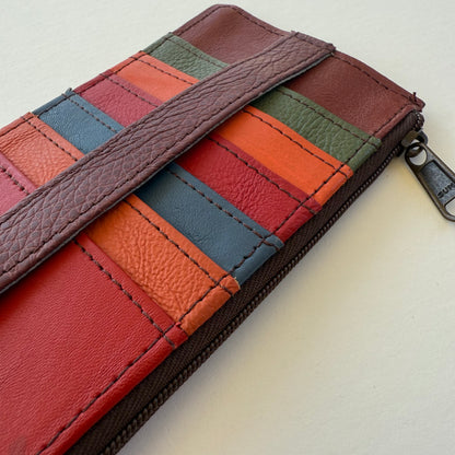close-up of Multicolored leather wallet with zipper on a light background
