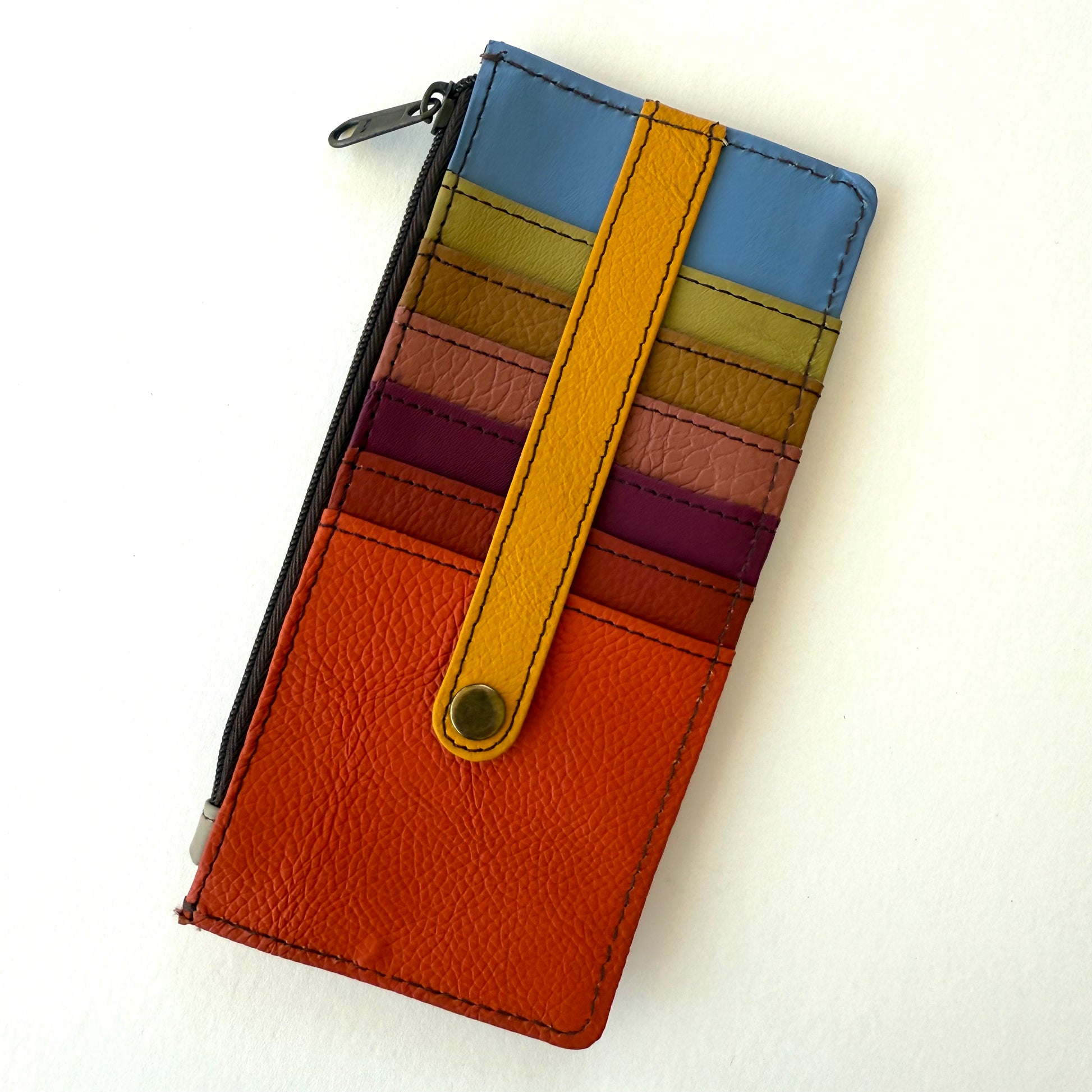 Colorful striped wallet with a yellow strap on a white background