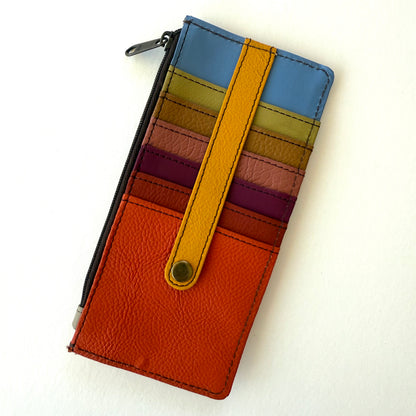 Colorful striped wallet with a yellow strap on a white background