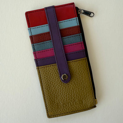back view of Multicolored wallet with a strap on a light background