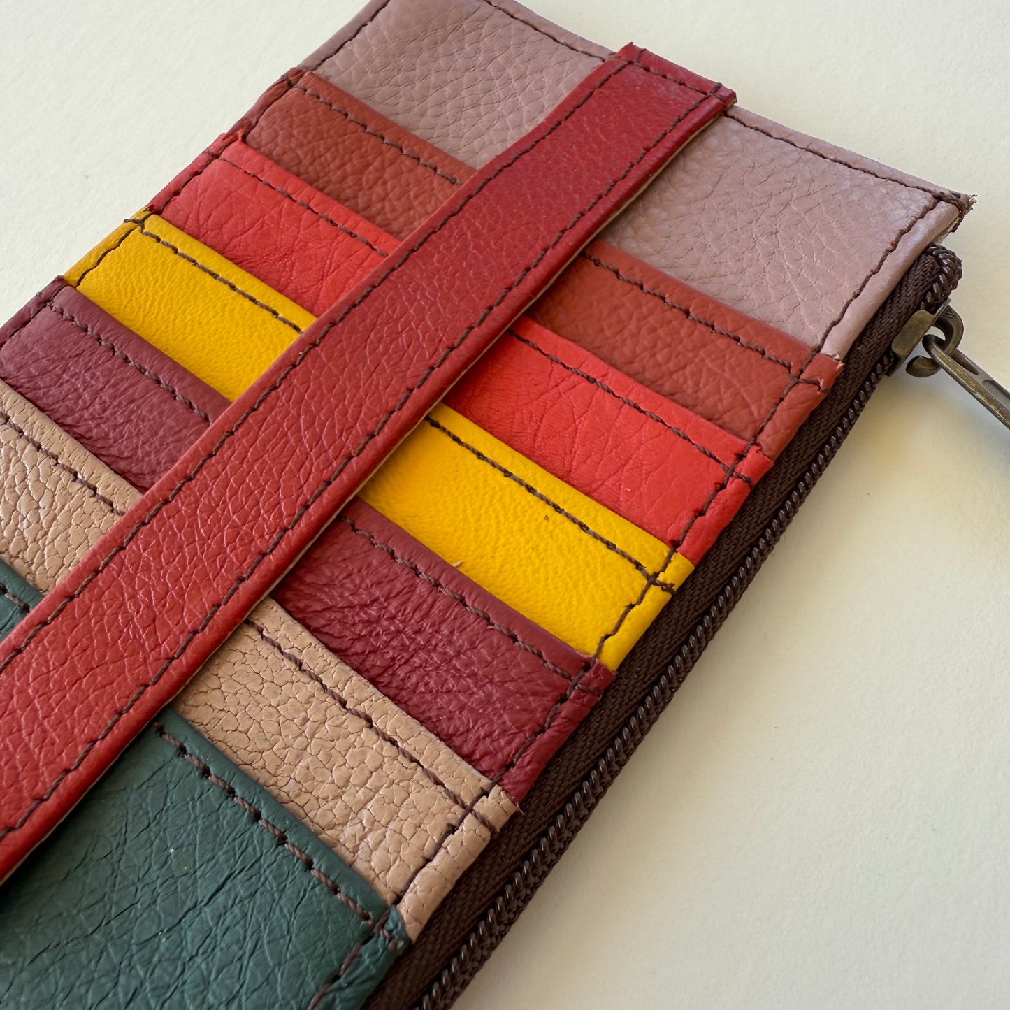 close-up of Multicolored leather wallet with a zipper on a light background
