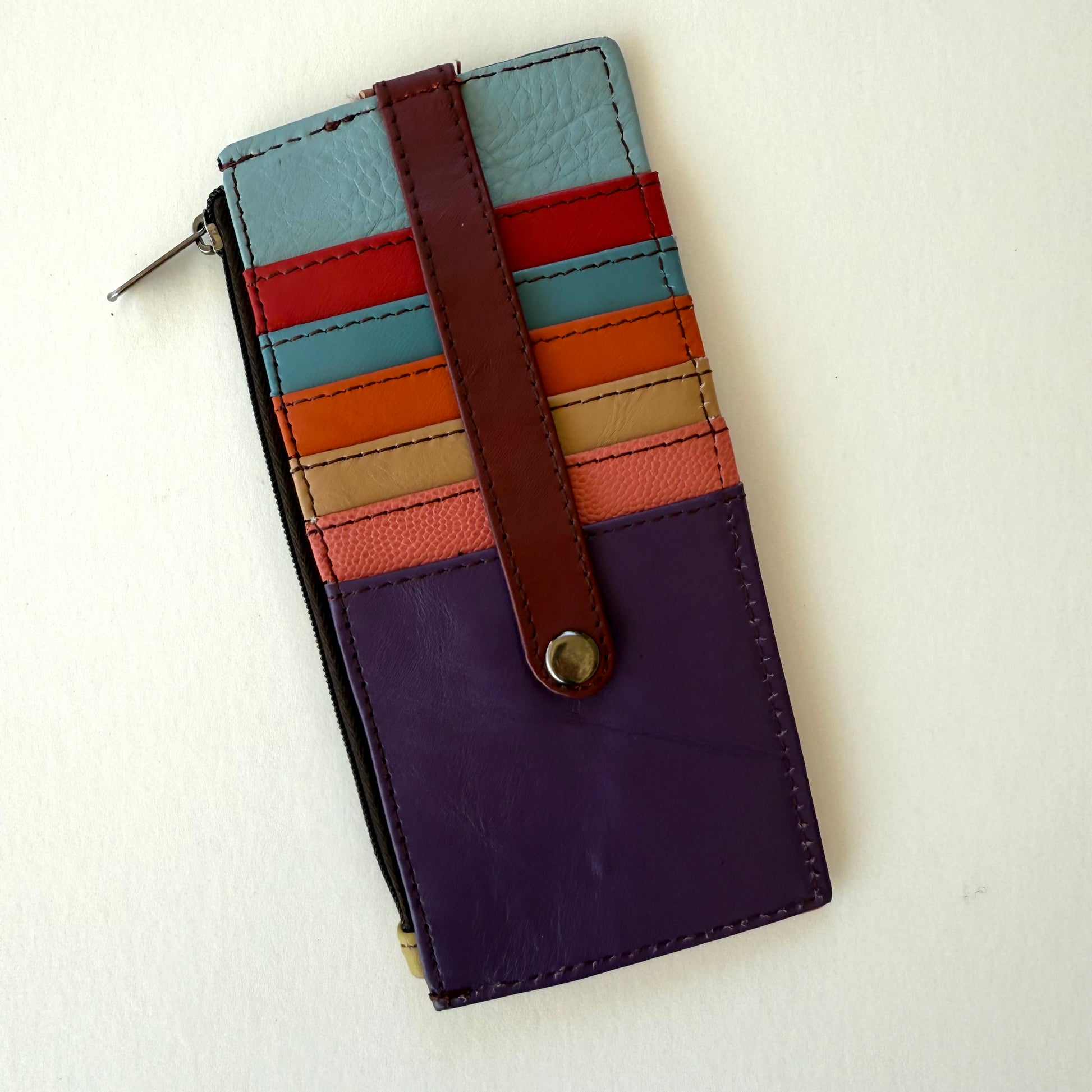 Multicolored striped wallet on a white background