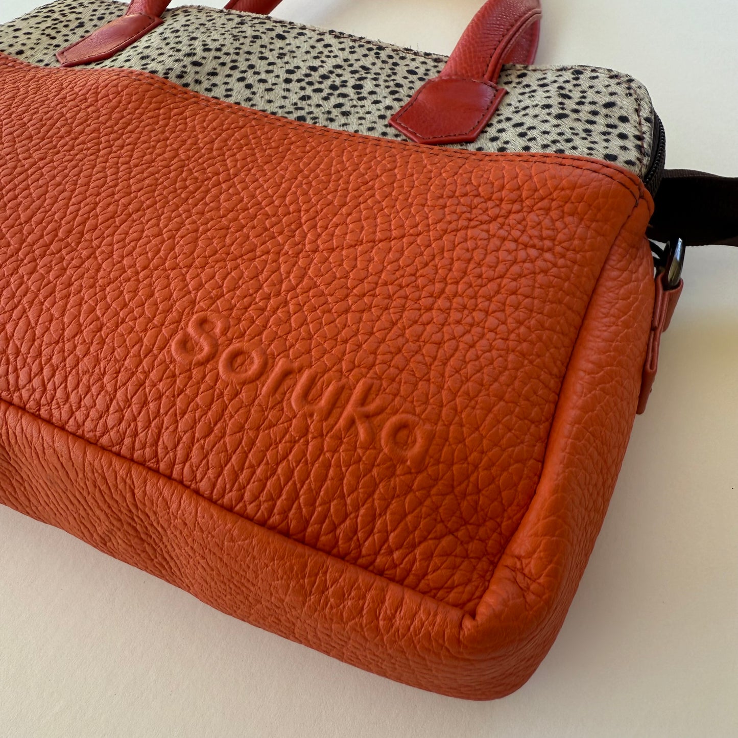 close-up of orange handbag