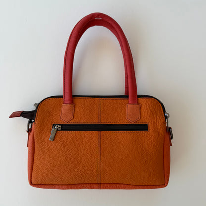 back view of orange handbag with zippered pocket