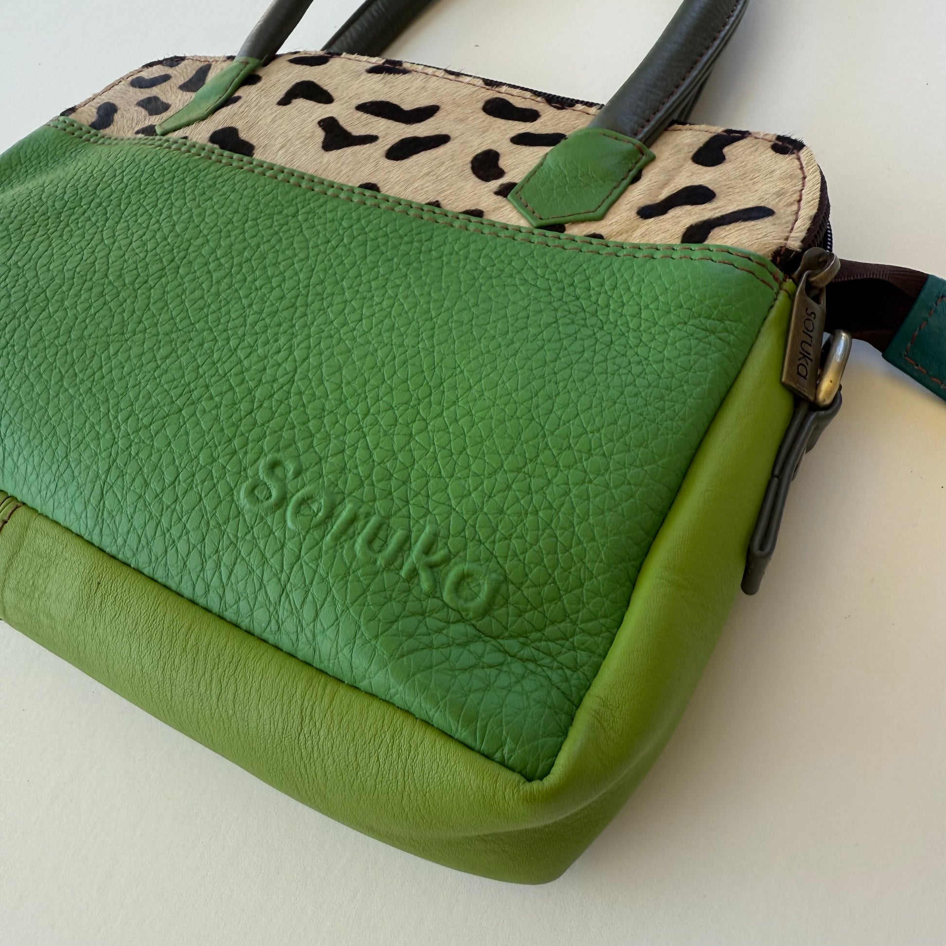 close-up of green leather handbag