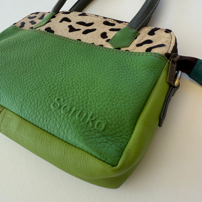 close-up of green leather handbag