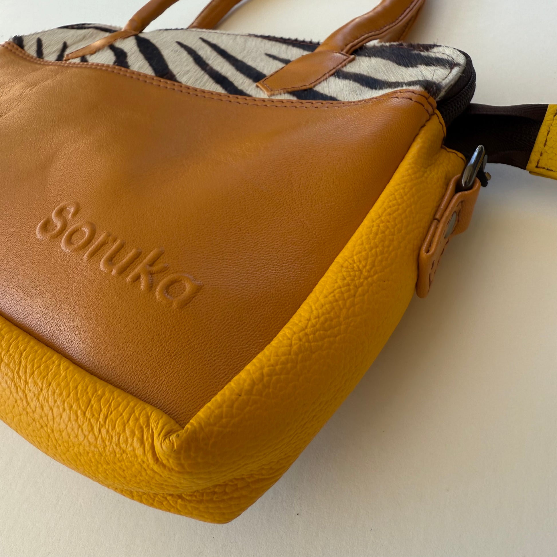 close-up of wheat colored handbag