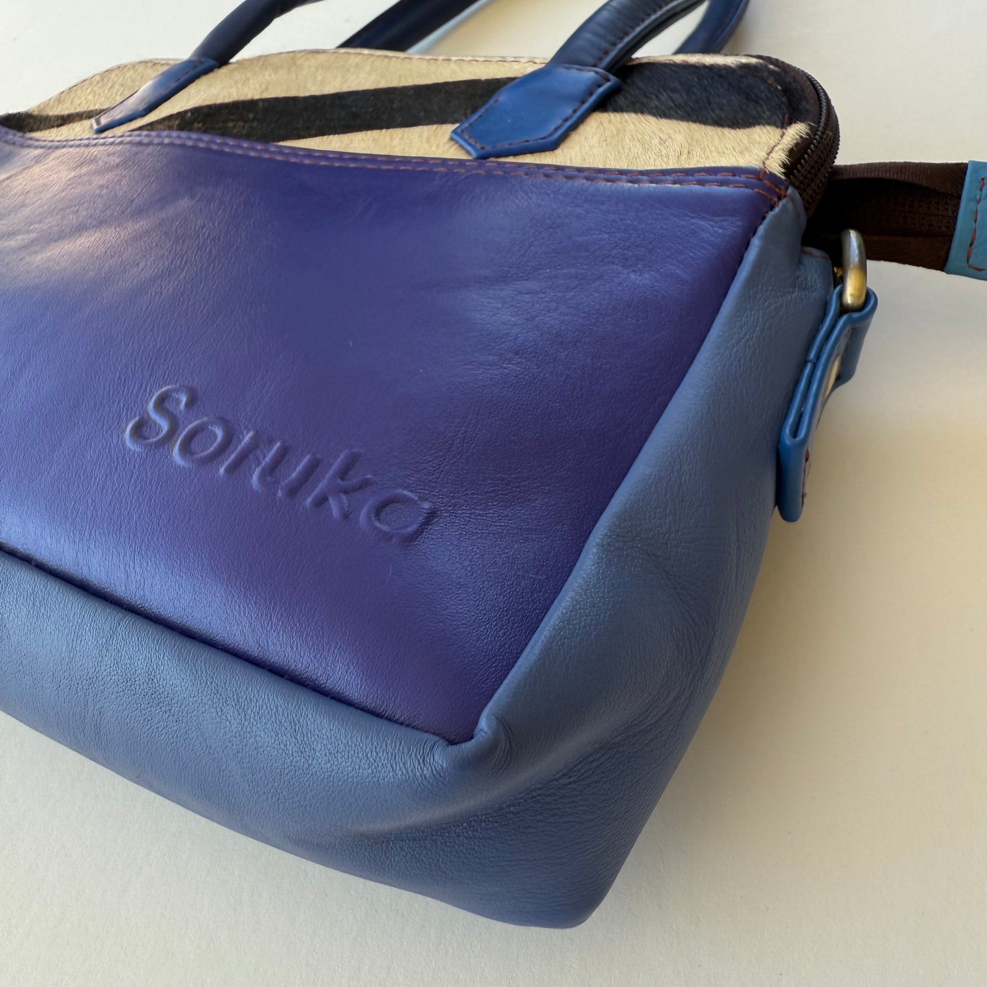 close-up of blue leather handbag