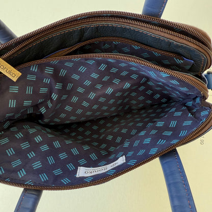 top view of blue leather handbag showing blue patterned interior