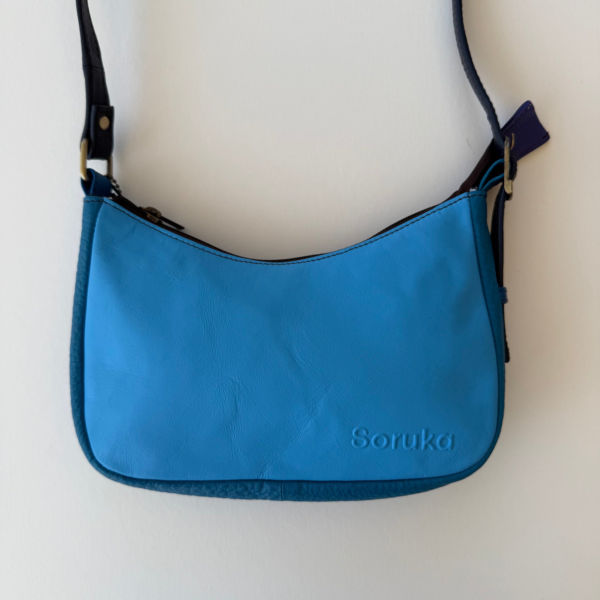 bright blue leather handbag shown on a white background