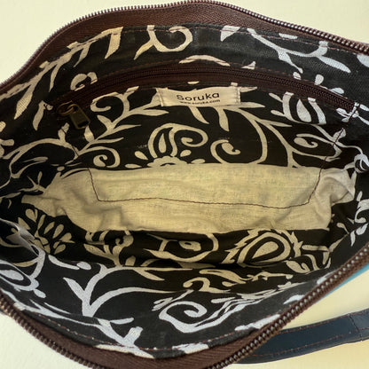 interior view of blue leather handbag with black and white patterned lining