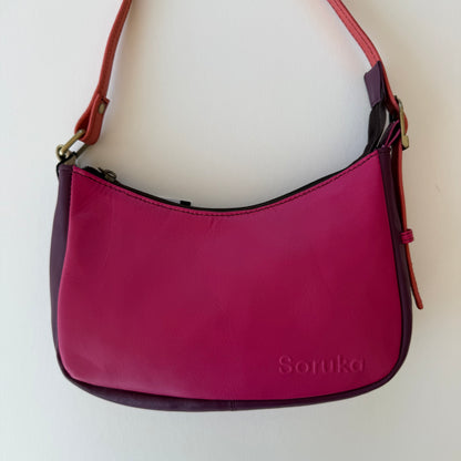 bright pink leather handbag shown on a white background