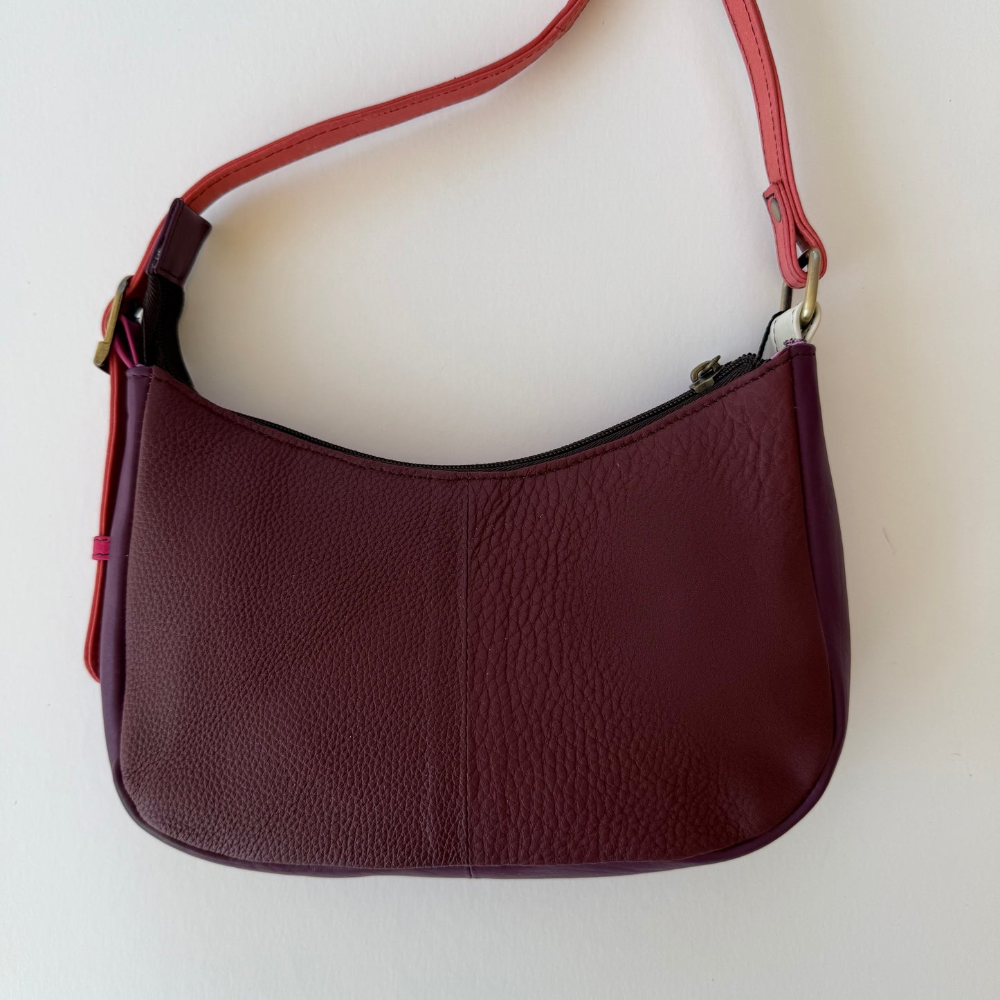 back view of leather handbag with maroon color