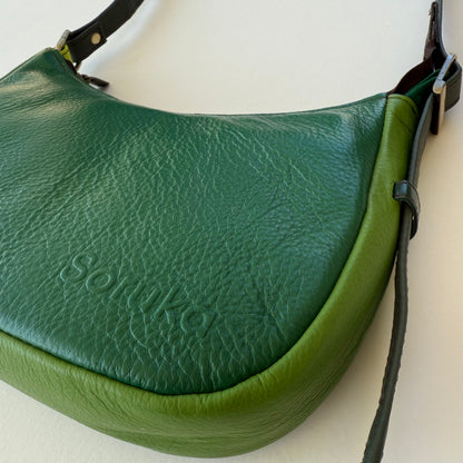 side view of green leather handbag