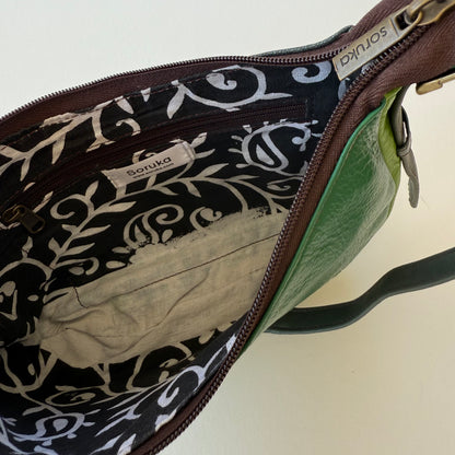 interior view of green leather handbag showing black and white patterned lining