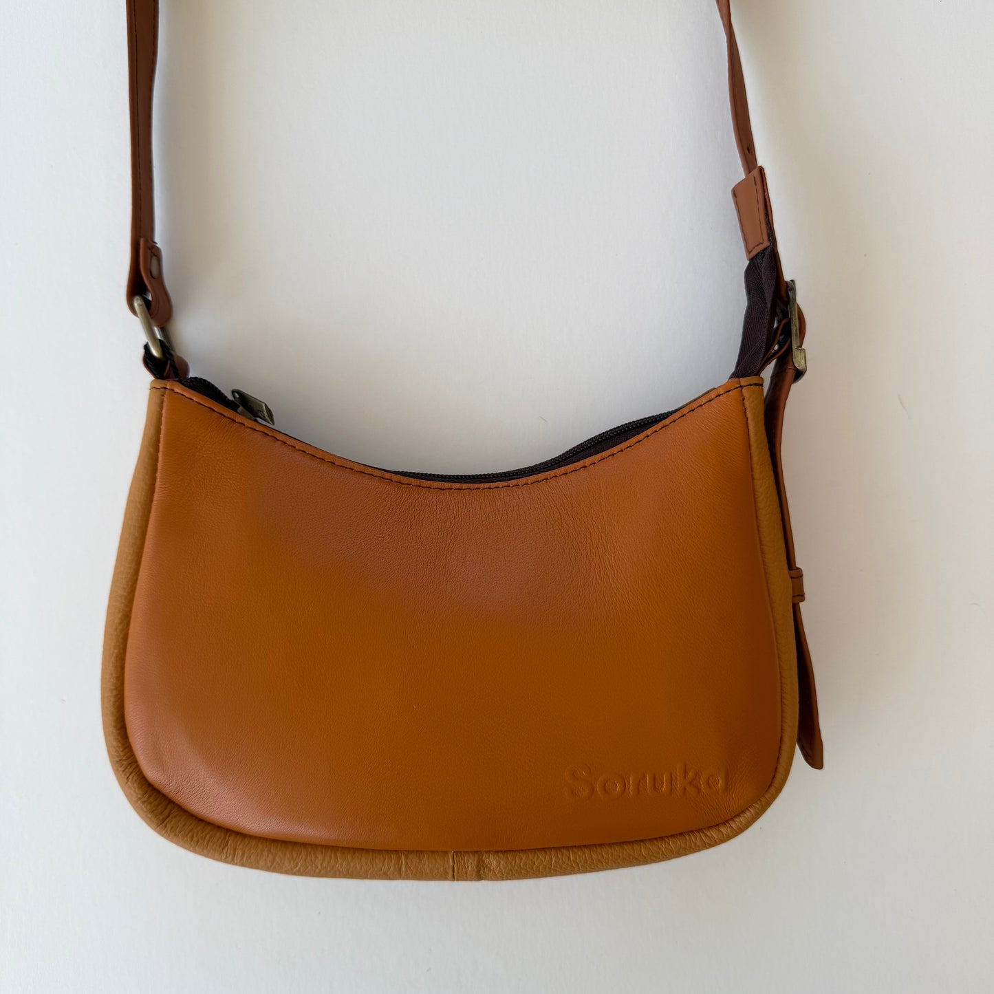 light Brown leather handbag on a white background