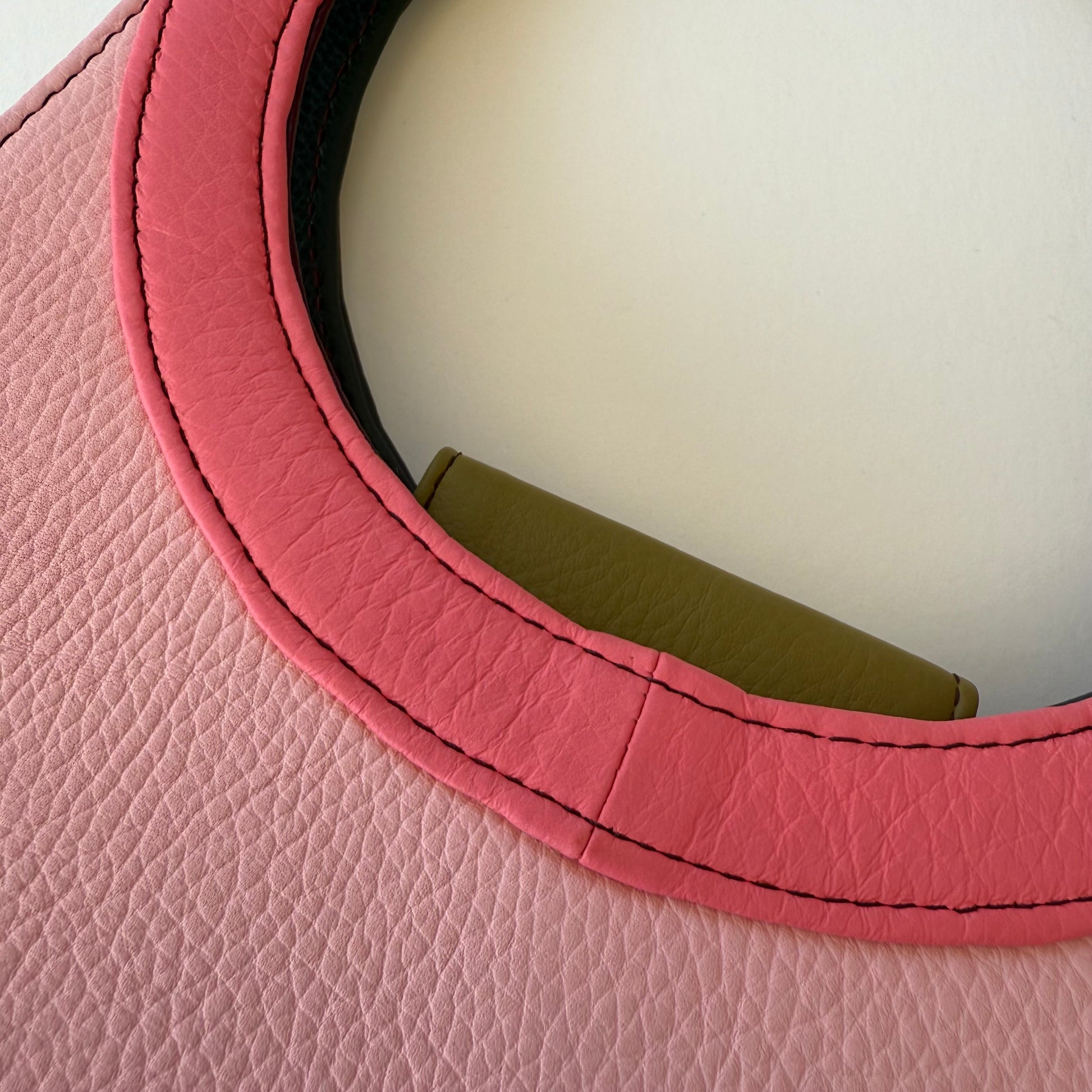 close-up of pink ring handle on purse